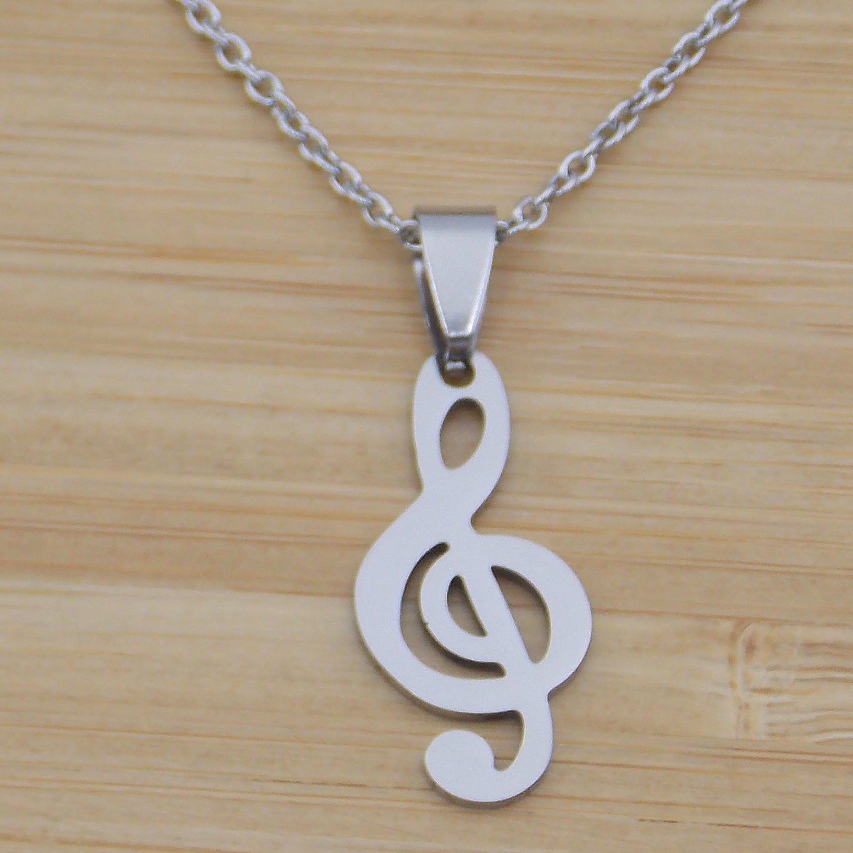 Colgante de acero inoxidable en forma de Clave de Sol